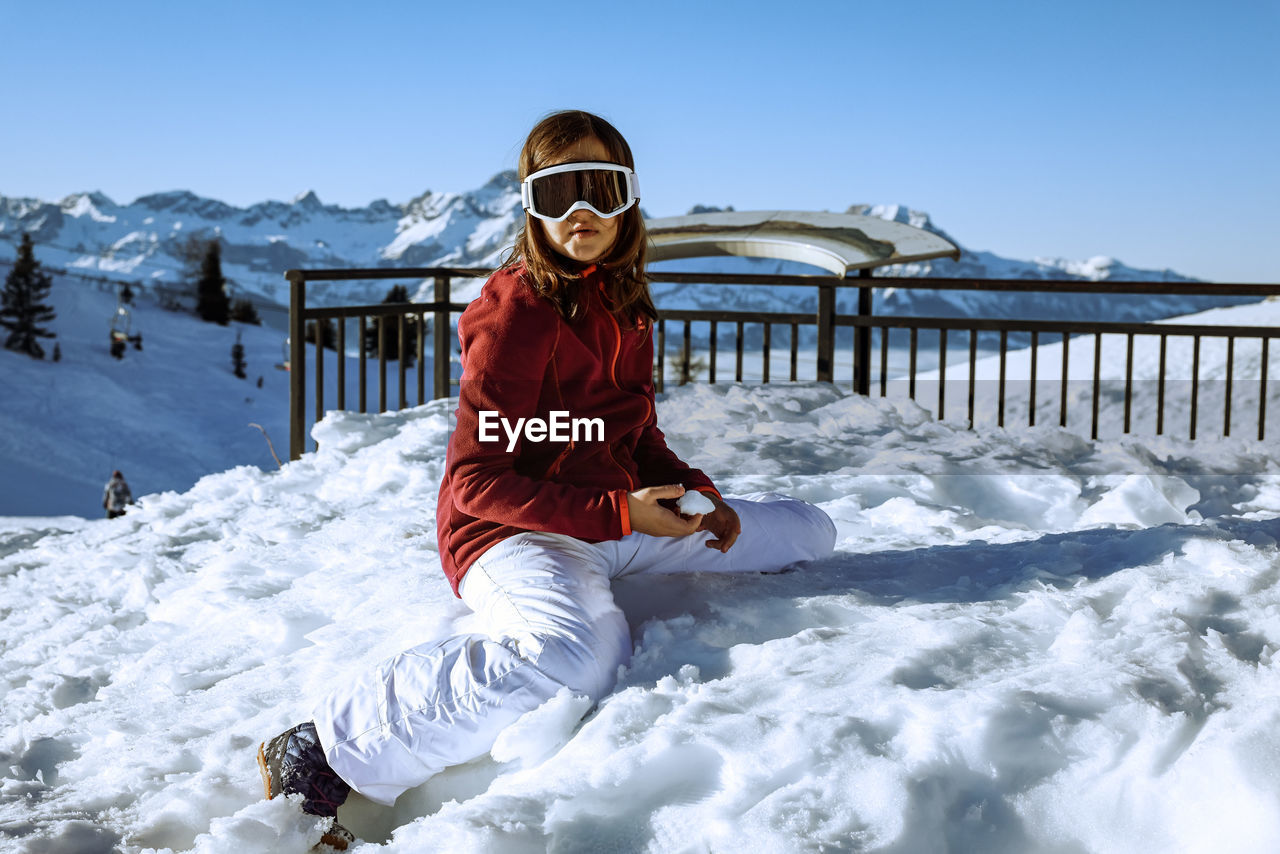 Portrait of woman skiing on snow