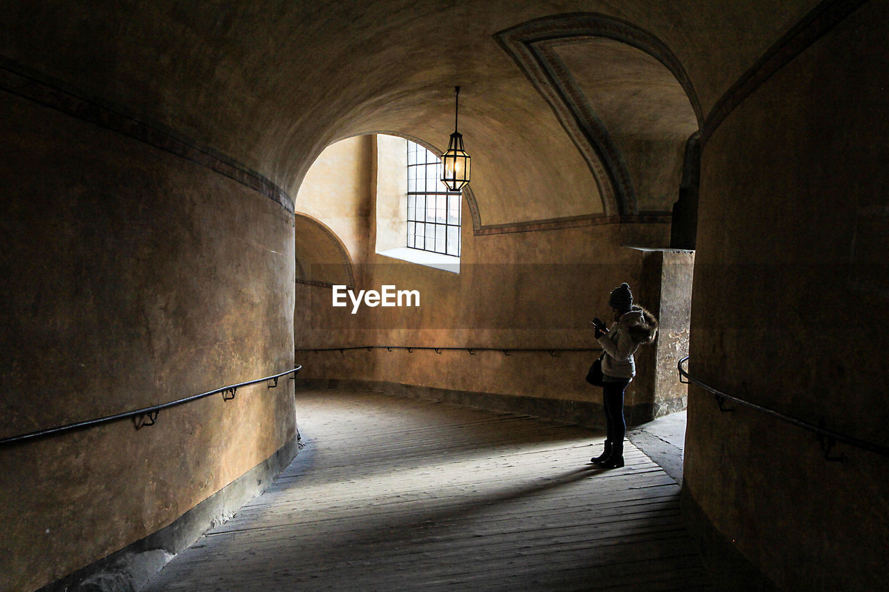 MAN STANDING IN CORRIDOR