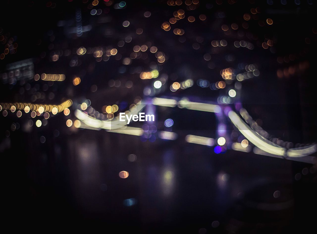 Defocused image of illuminated tower bridge at night