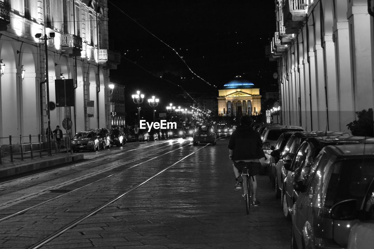 STREET LIGHTS IN ILLUMINATED CITY AT NIGHT