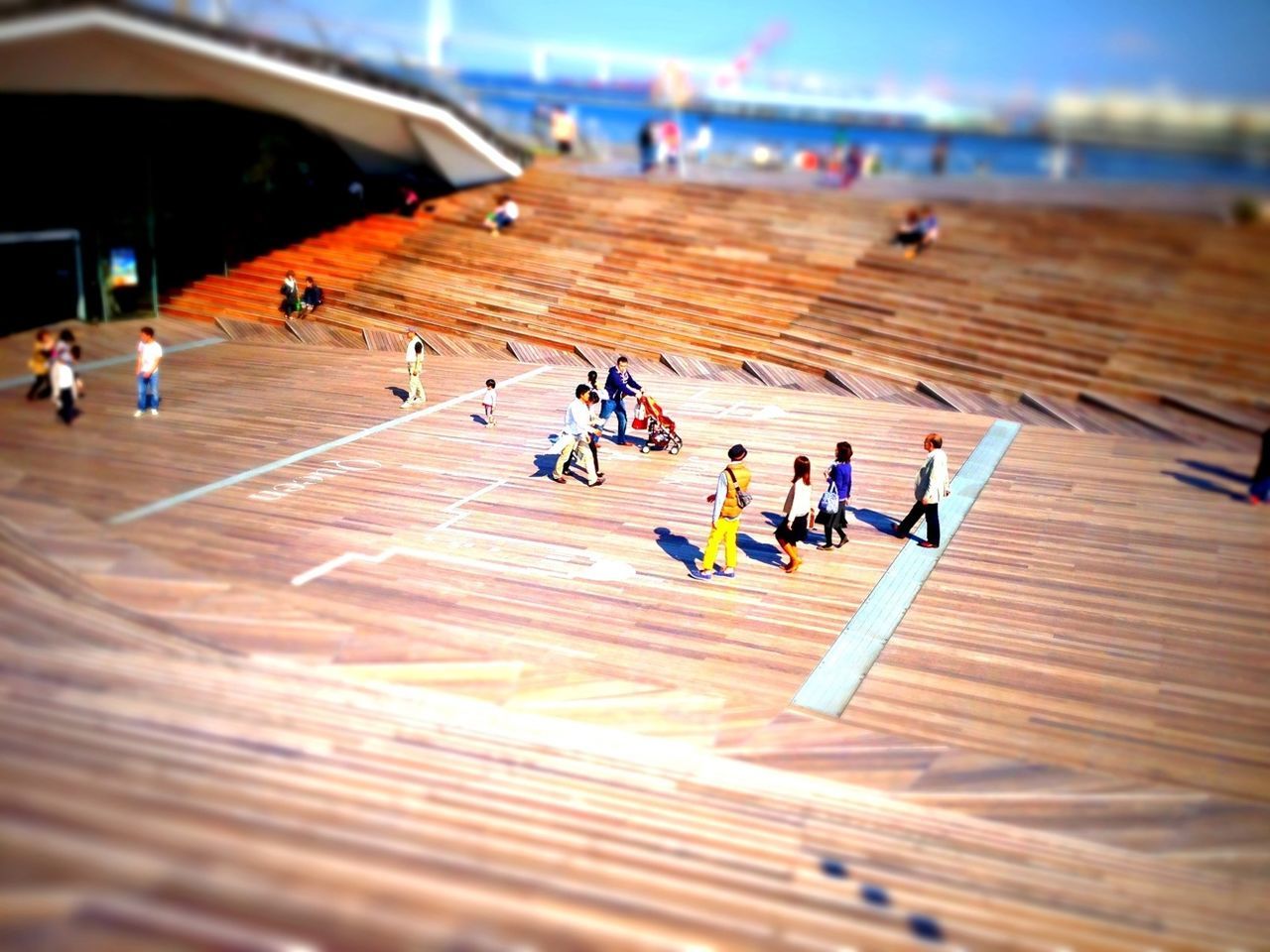 Tilt-shift image of people at osanbashi pier