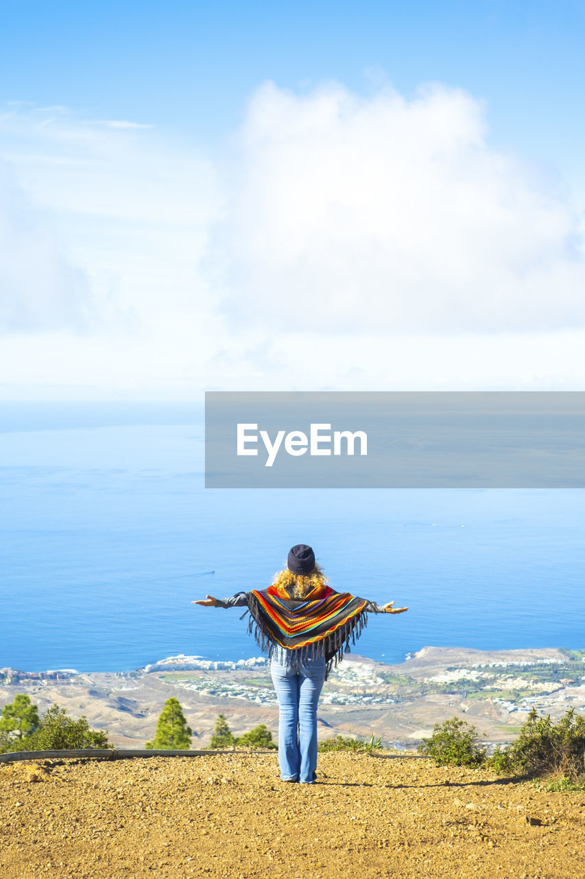 rear view of woman looking at sea against sky