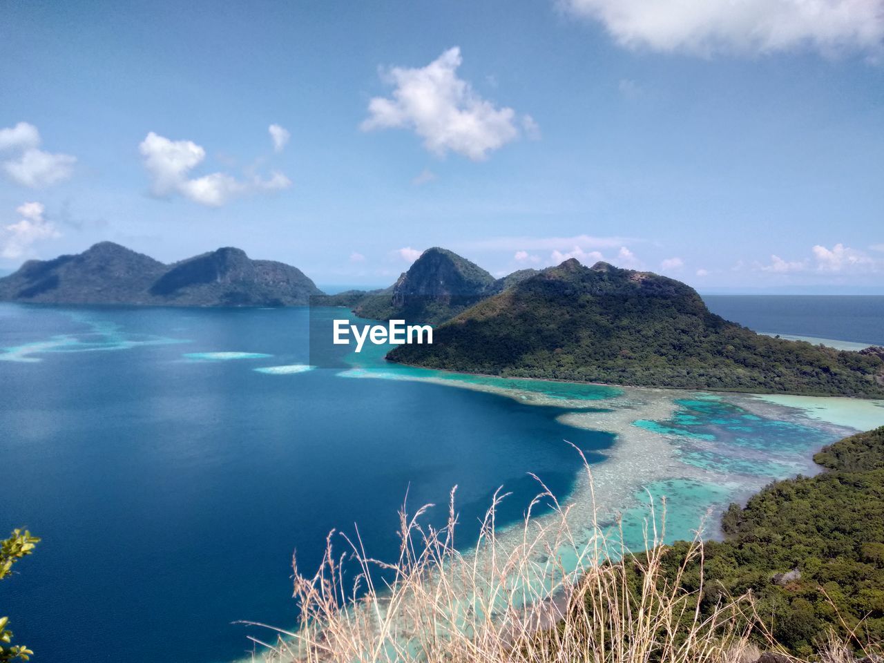 Scenic view of sea and mountains against sky