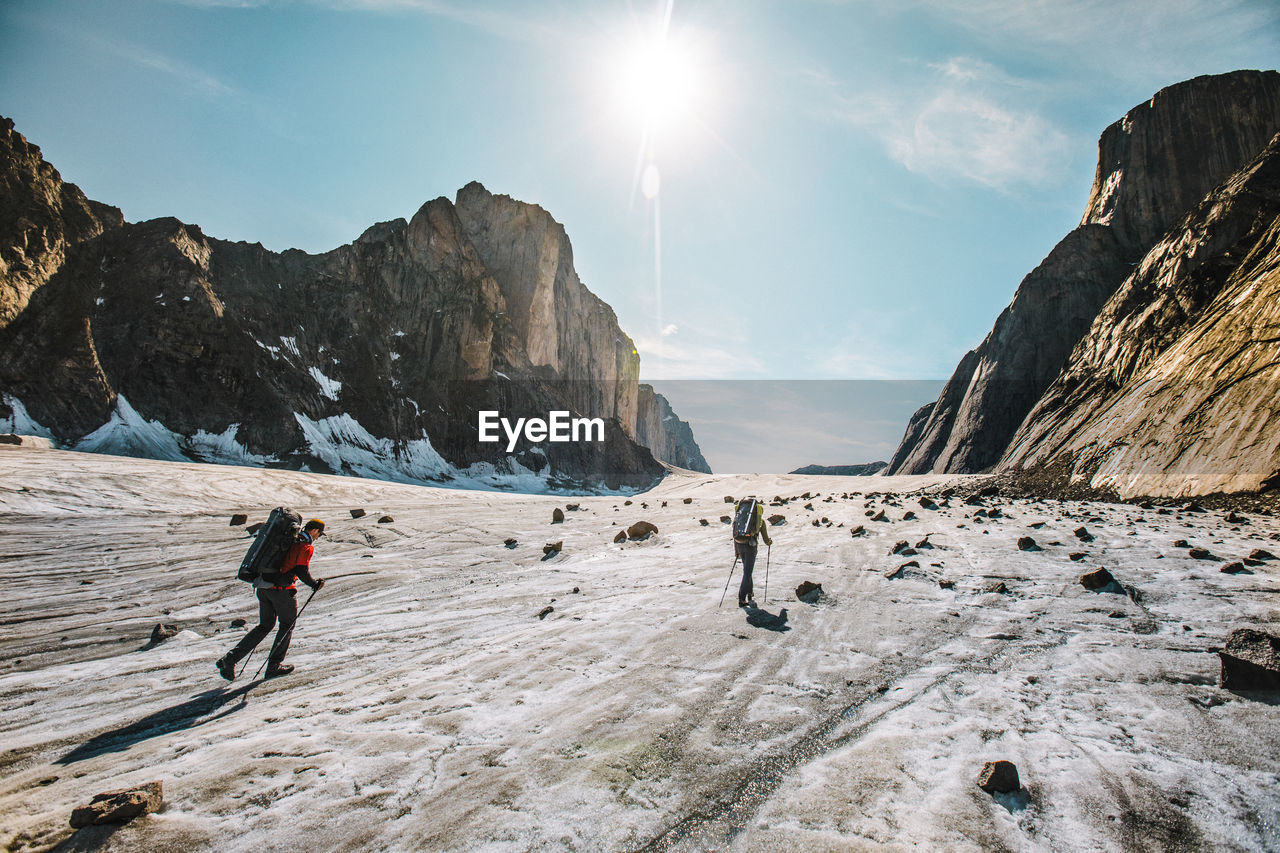 Rear view of explorers crossing the parade glacier, baffin island.