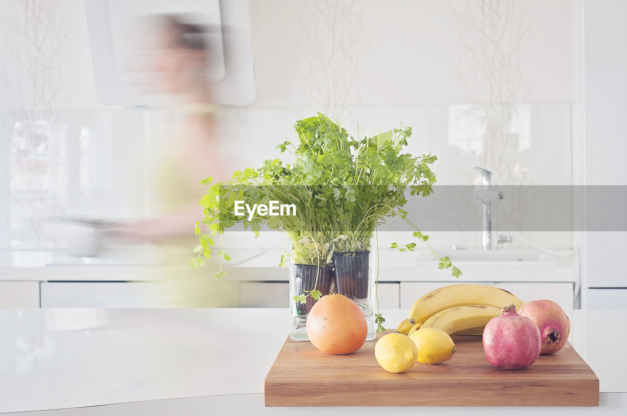 Quick cooking, healthy vegetarian food. fruits and herbs on clean table, pomegranate, lemons, herbs