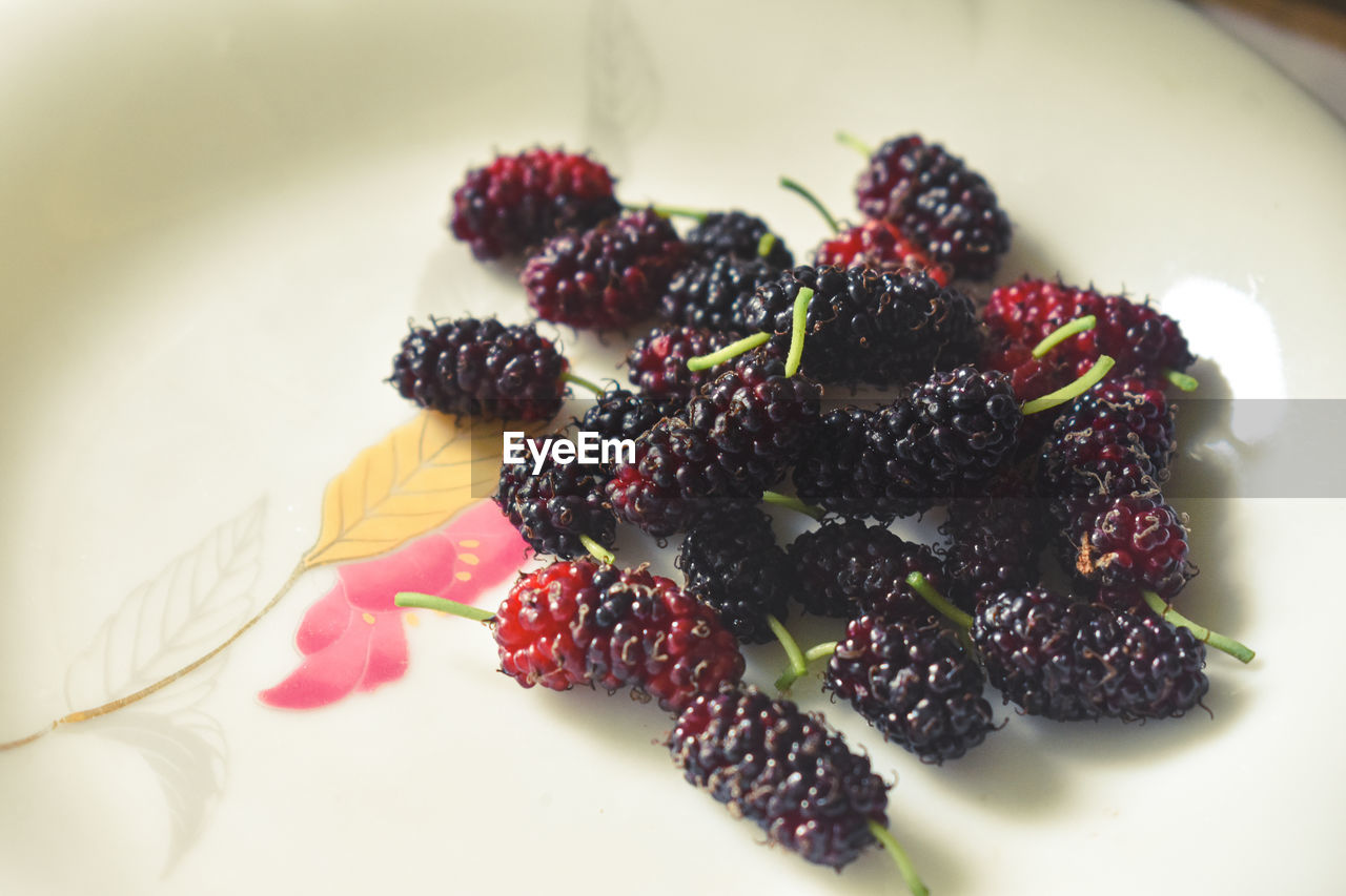 Close-up of mulberries in plate on table