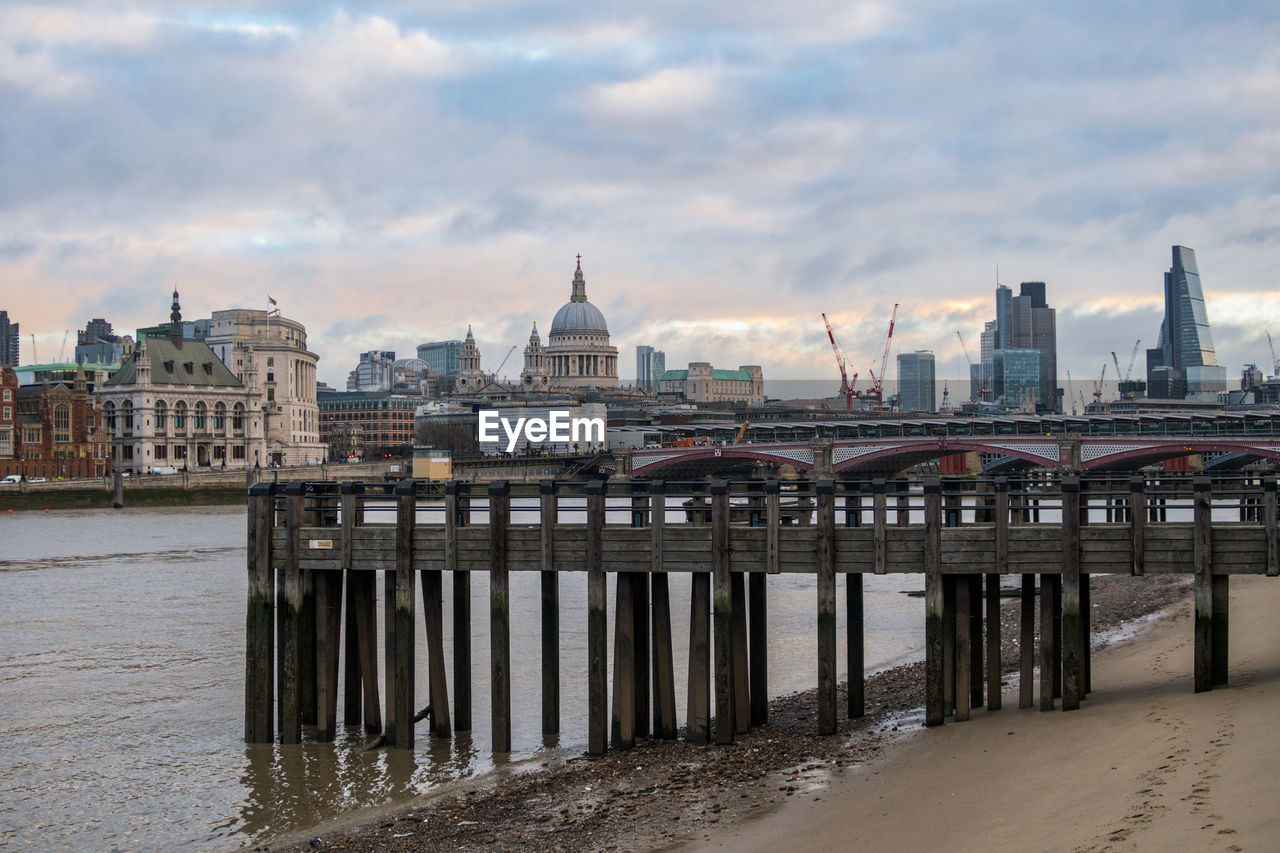 Bridge over river with buildings in background