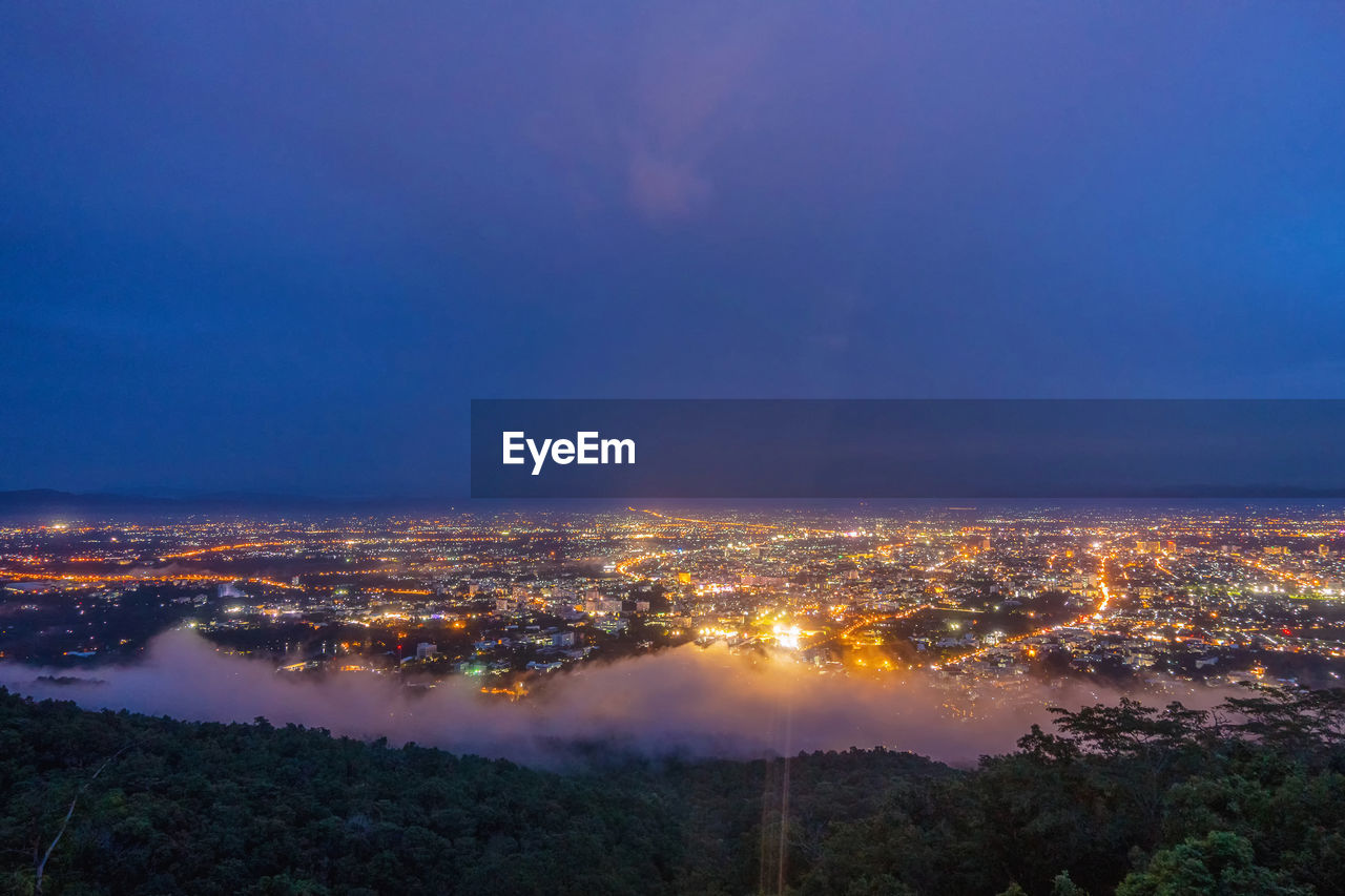 AERIAL VIEW OF CITYSCAPE AGAINST BLUE SKY