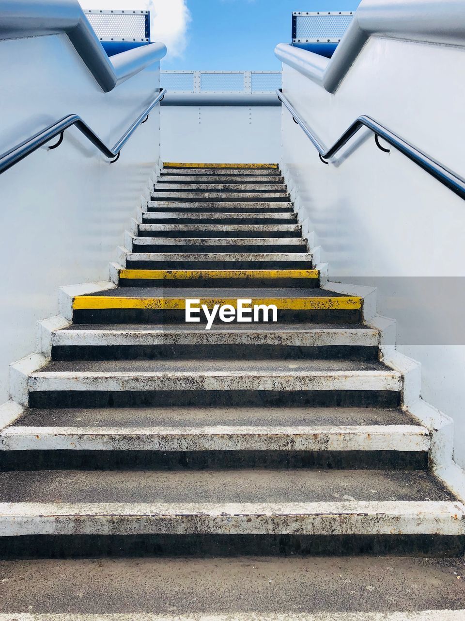 Ascending staircase at a train station 