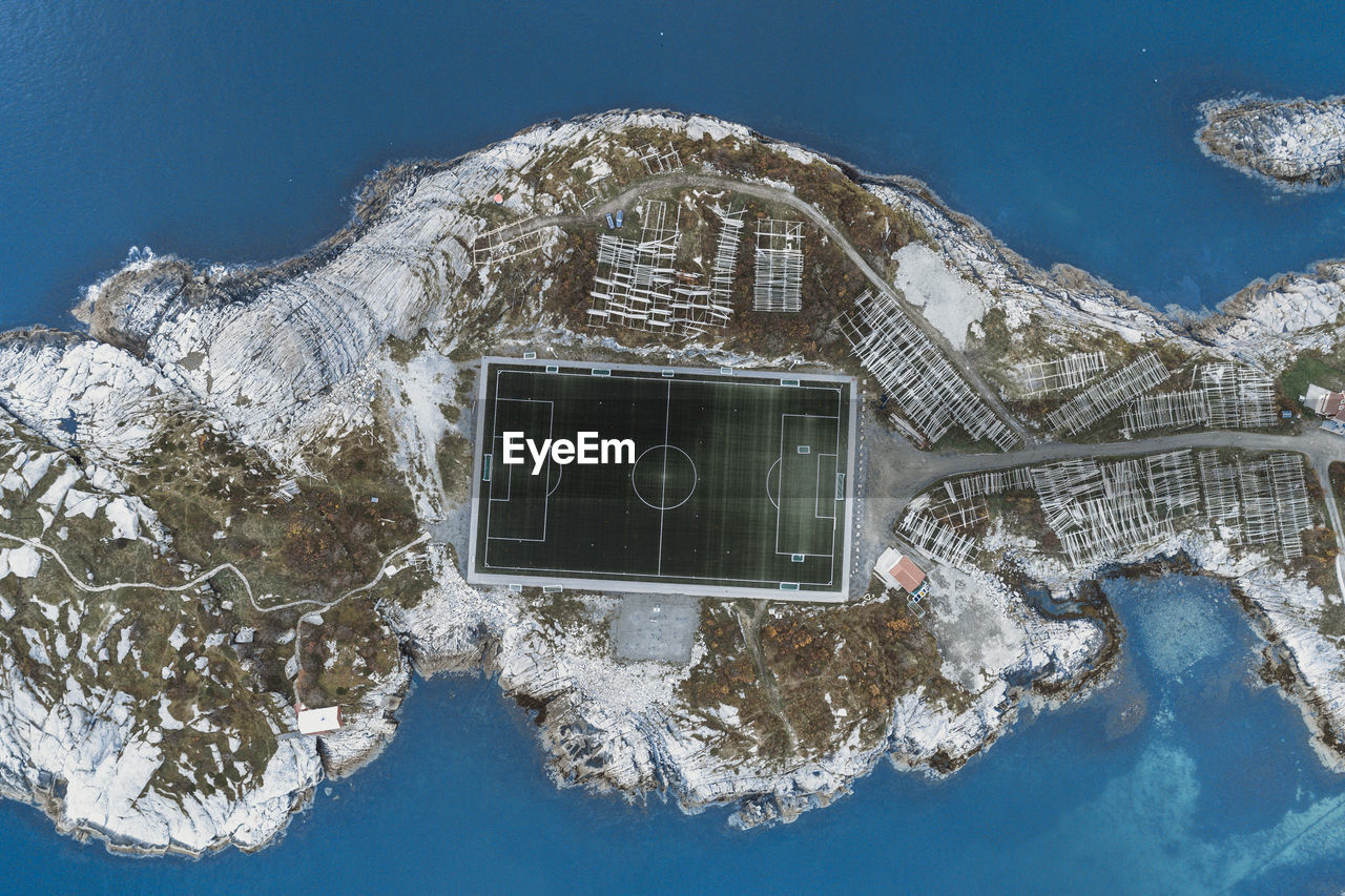 Soccer field on the cliffs of henningsvær by the sea