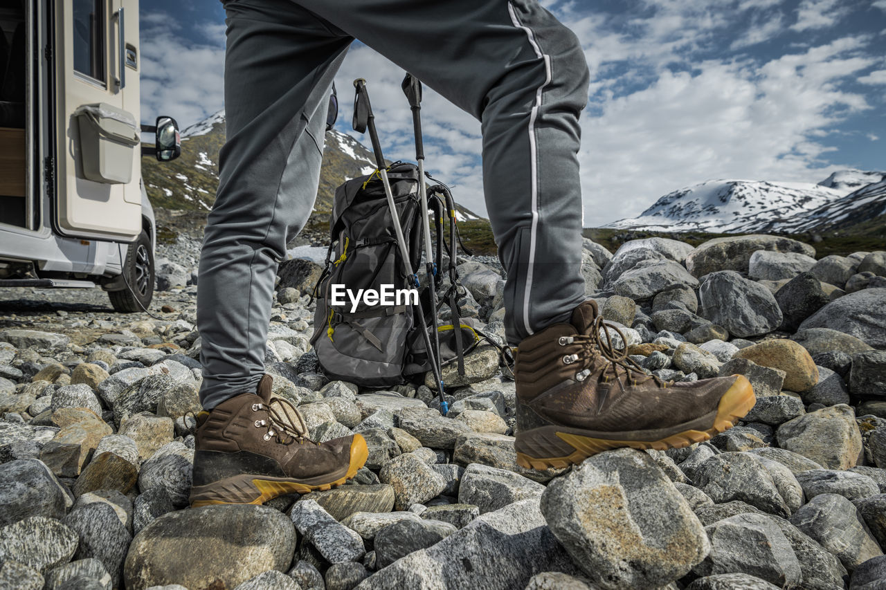 low section of man standing on rocks