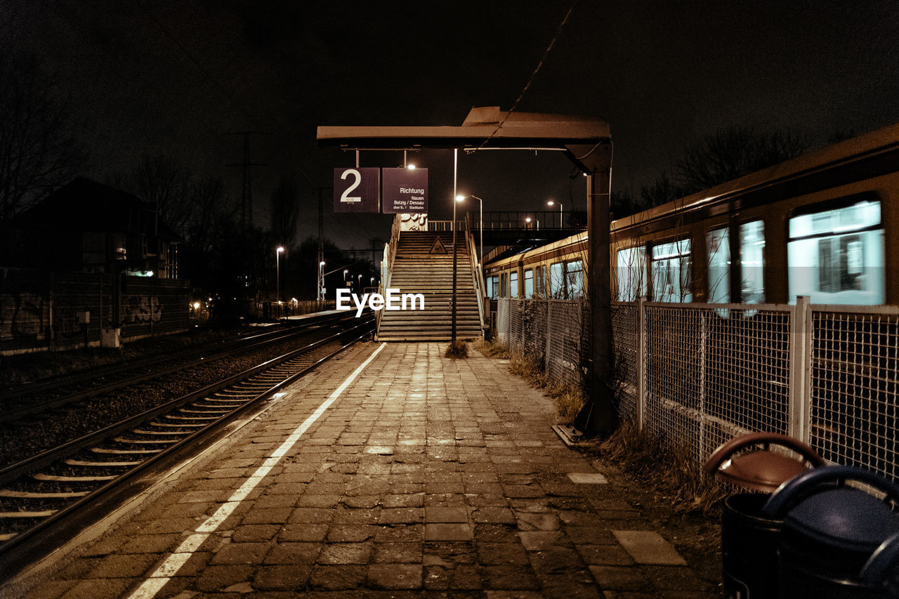 Empty railroad station platform at night