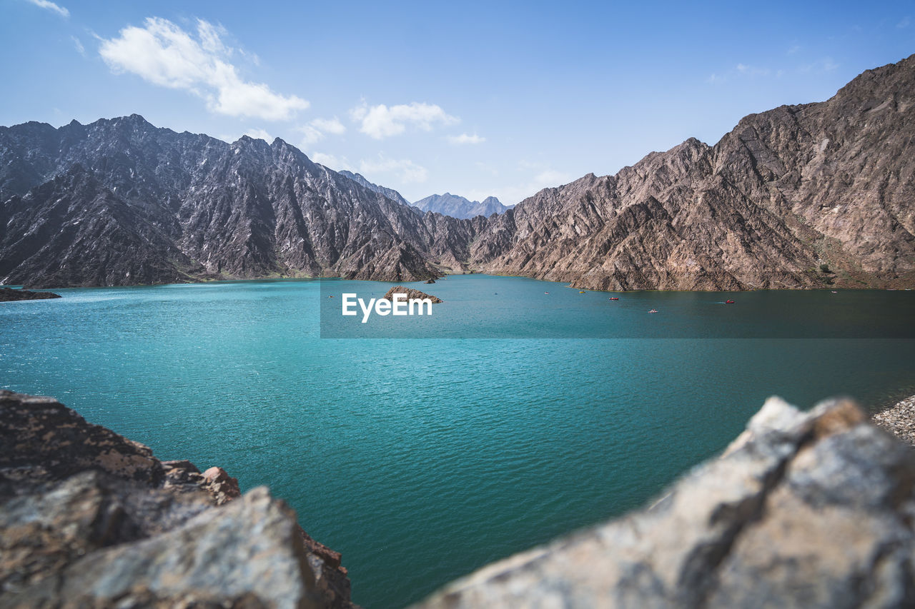 Scenic view of lake and mountains against sky