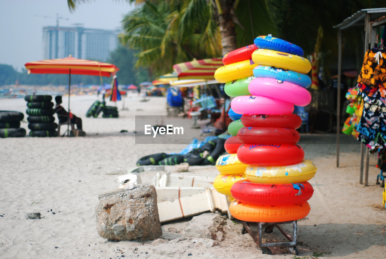 Colorful inflatable rings stack at beach