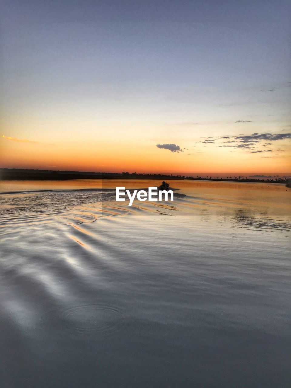 SCENIC VIEW OF CALM SEA AT SUNSET