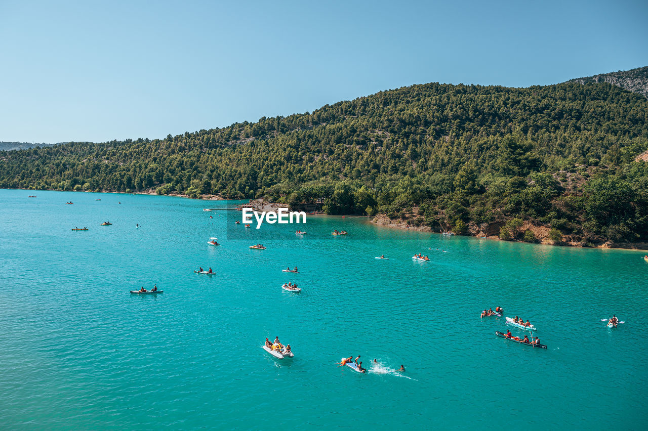 High angle view of boats in sea against clear sky