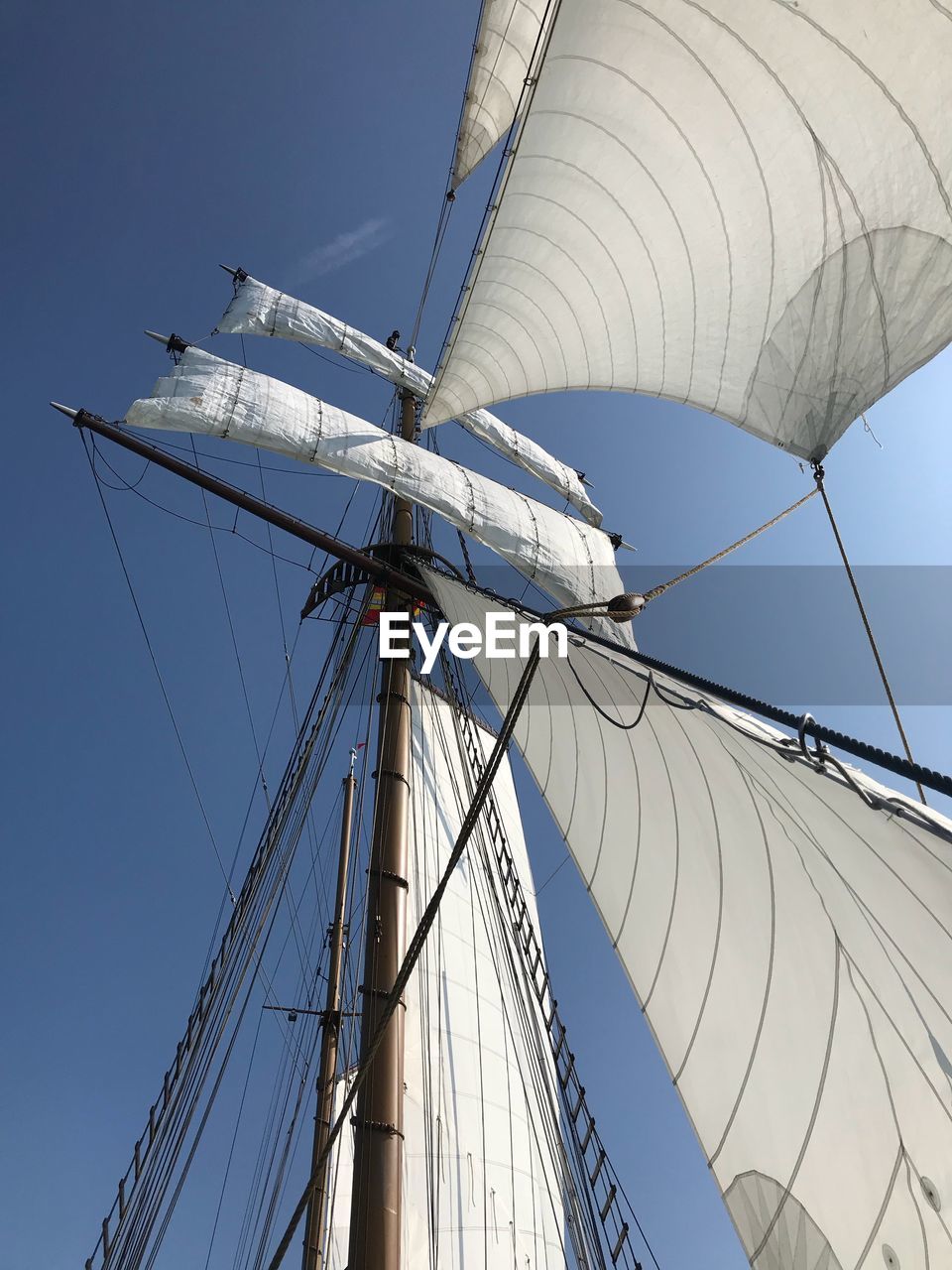 Low angle view of sailboat against clear sky