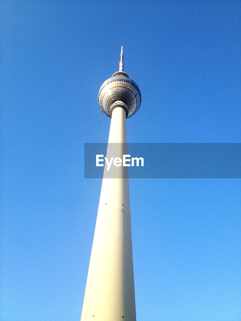 Low angle view of fernsehturm against clear blue sky