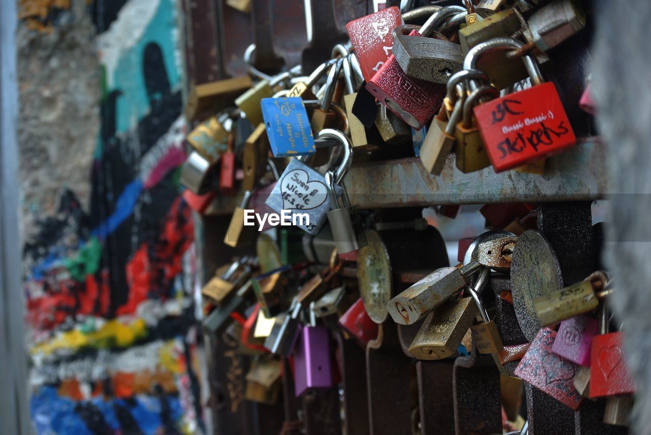 Padlocks hanging on railing