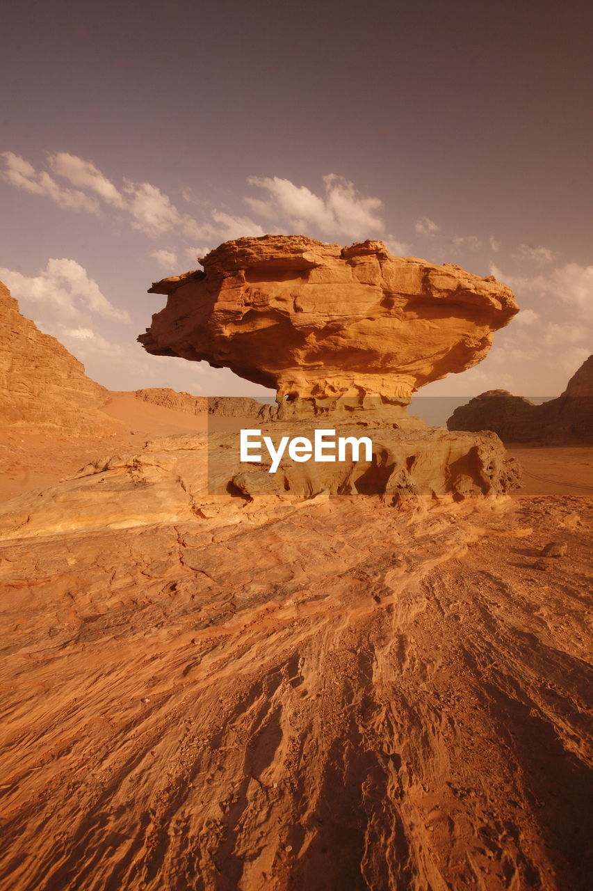 Low angle view of rock formation against sky during sunny day