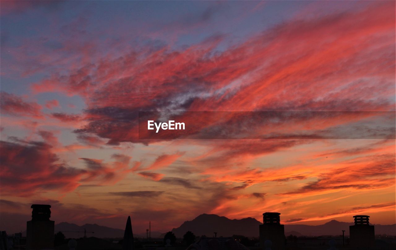 sky, afterglow, sunset, cloud, architecture, red sky at morning, dawn, building exterior, built structure, horizon, city, dramatic sky, building, silhouette, orange color, nature, landscape, beauty in nature, evening, cityscape, urban skyline, scenics - nature, skyline, no people, environment, outdoors, romantic sky, residential district, travel destinations, cloudscape, red, city life, multi colored, pink, moody sky, sun