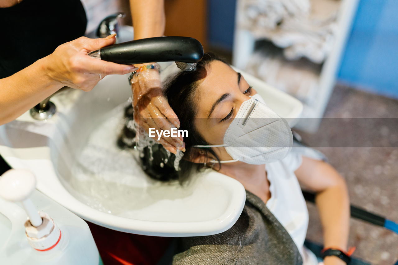 Woman in the hairdresser's washing her hair