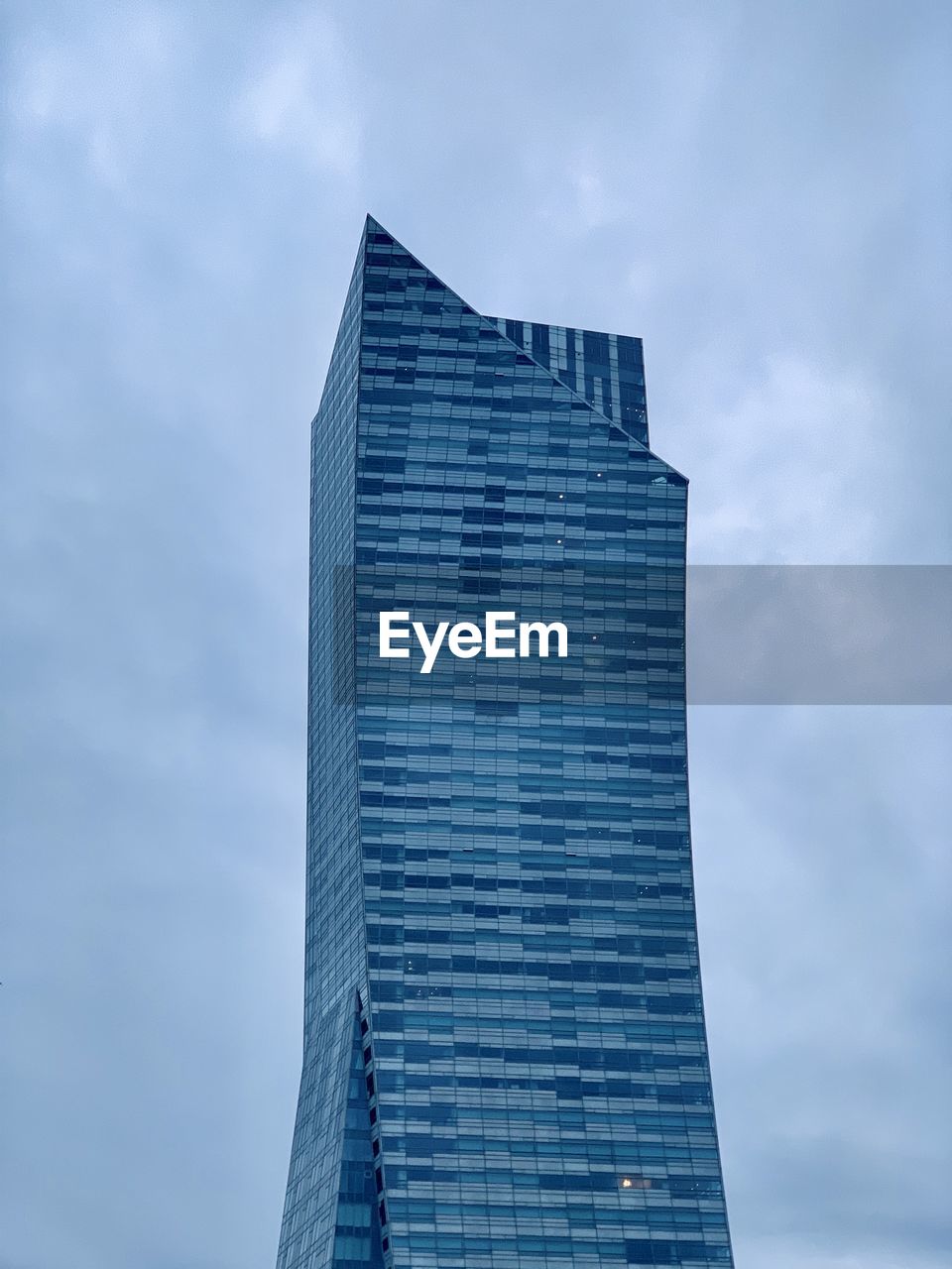 Low angle view of modern building against sky in warsaw. 