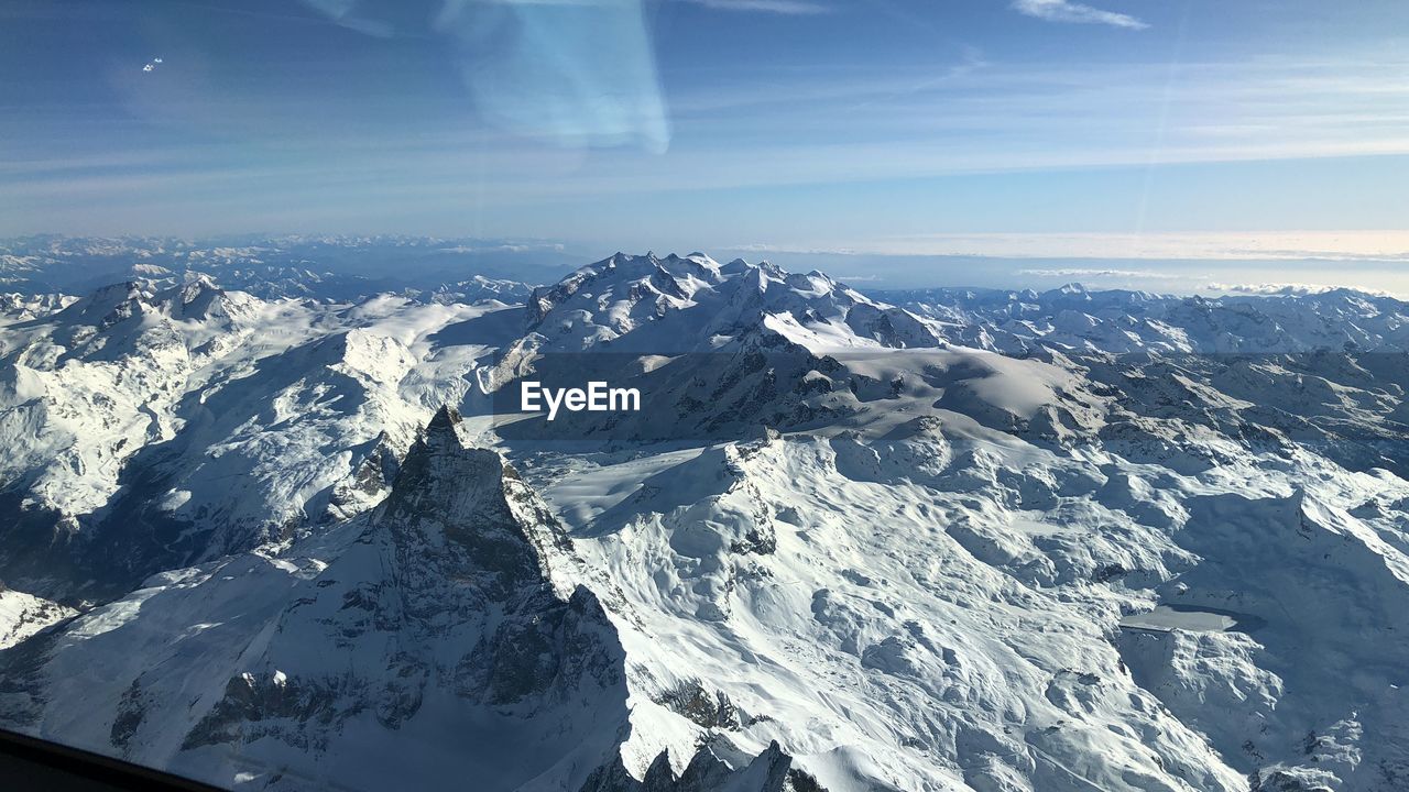 Scenic view of snowcapped mountains against sky