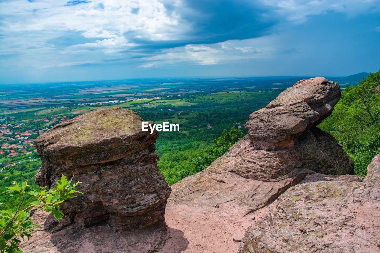 Rock formations on landscape against sky