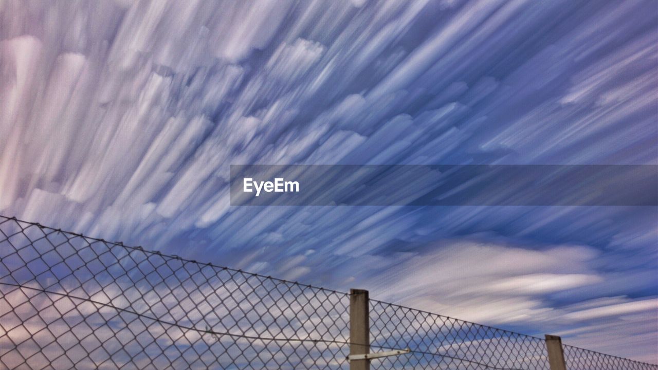 SCENIC VIEW OF SKY SEEN THROUGH CHAINLINK FENCE