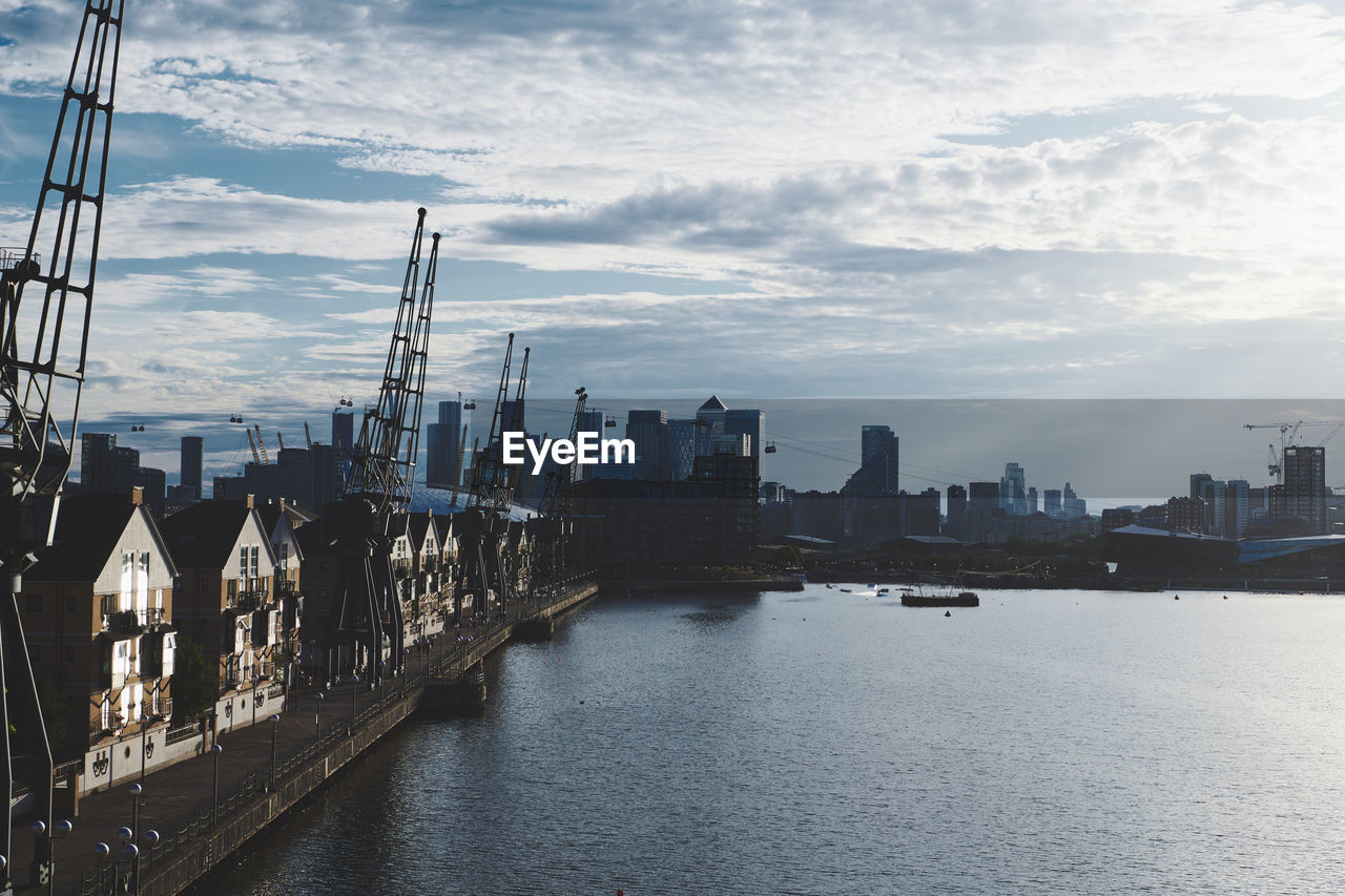 Bridge over river amidst buildings in city of london against sky