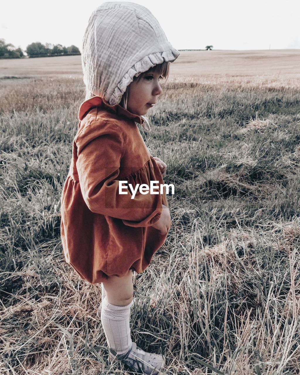 Full length of toddler girl standing on field