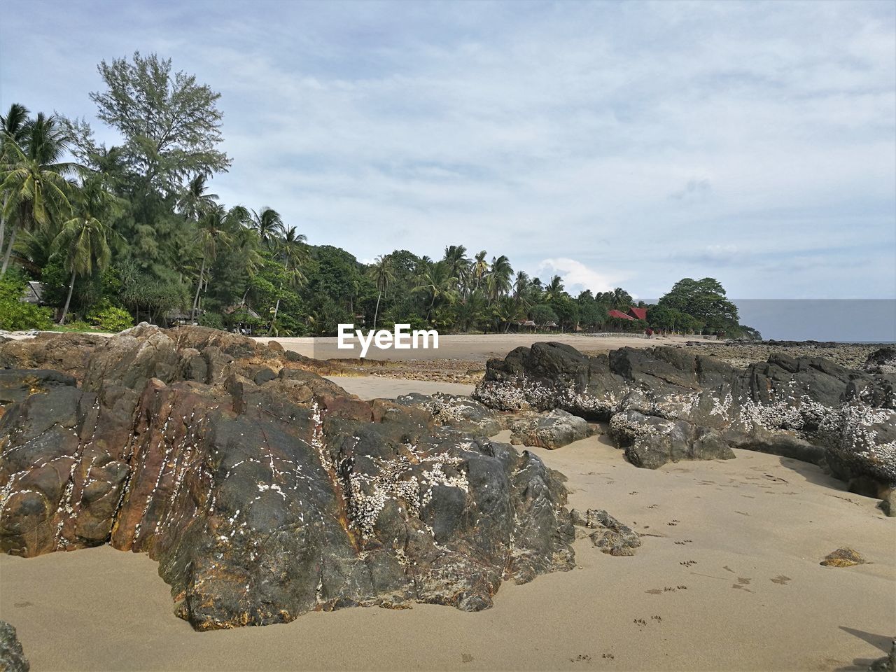 ROCKS ON BEACH AGAINST SKY