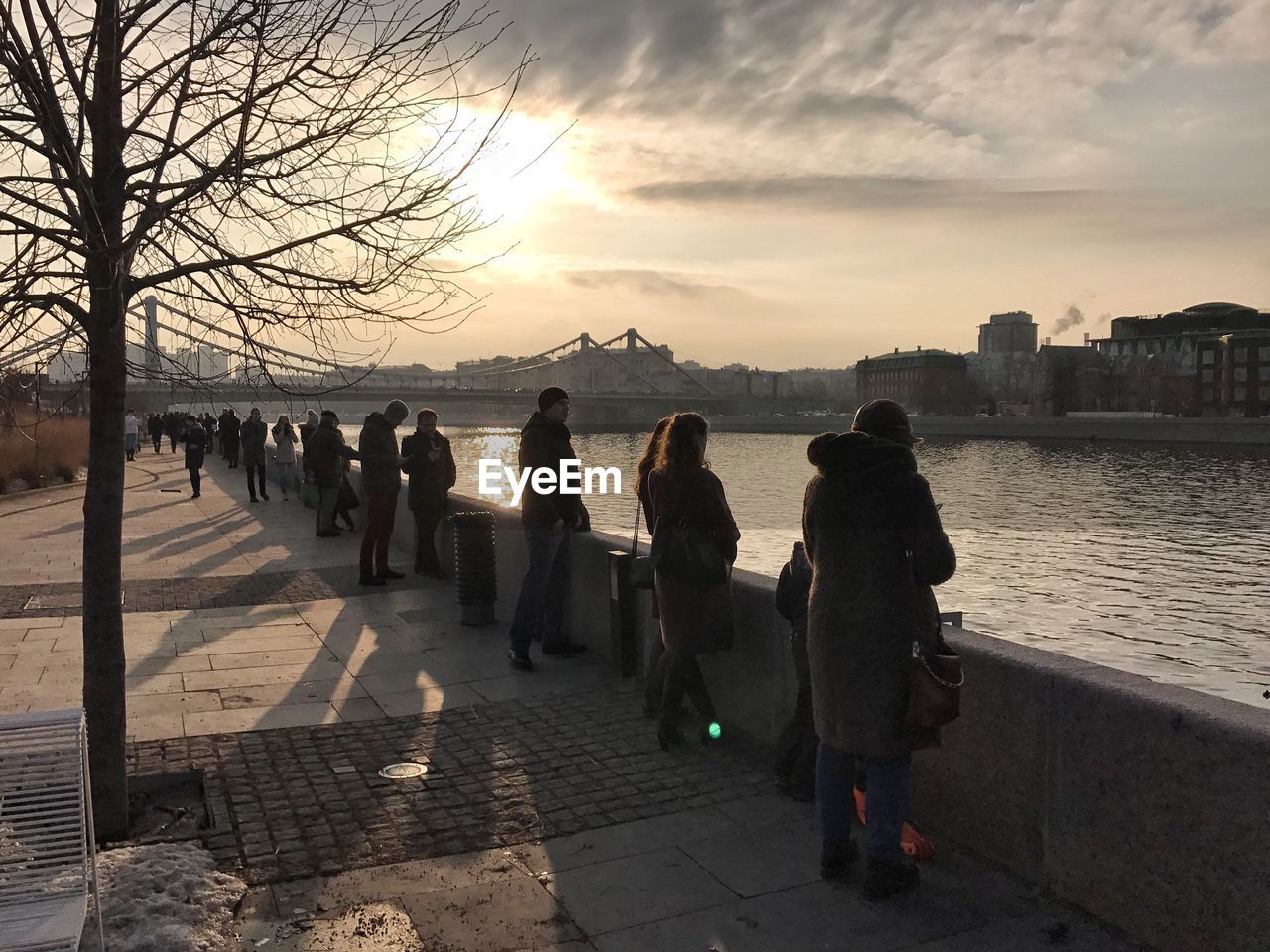 PEOPLE ON BEACH AGAINST SKY DURING SUNSET