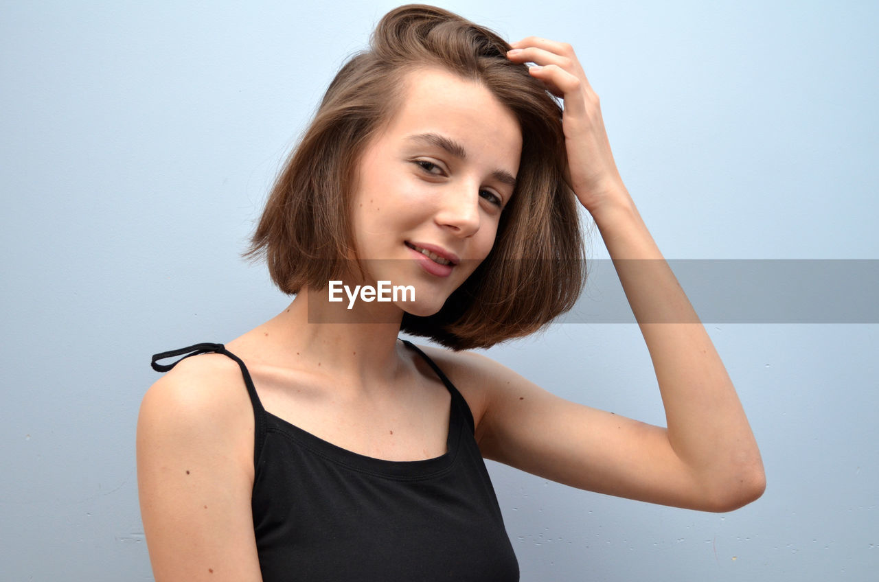 Portrait of smiling girl against white background