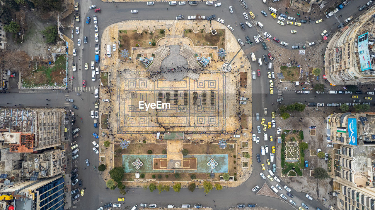 city, architecture, aerial photography, aerial view, built structure, bird's-eye view, building exterior, metropolitan area, transportation, metropolis, street, residential area, road, cityscape, high angle view, neighbourhood, mode of transportation, building, motor vehicle, car, city street, urban area, travel destinations, travel, traffic, no people, outdoors, directly above, land vehicle, city life, nature, residential district, day, highway, tourism, urban design