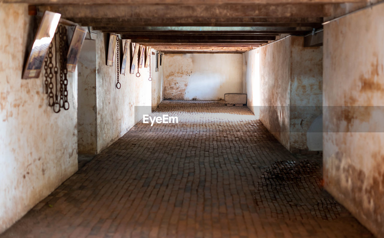 architecture, building, indoors, wood, built structure, corridor, no people, arcade, wall - building feature, room, old, the way forward, history, flooring, floor, wall, day, entrance, absence, the past, hall, door, house, interior design, empty