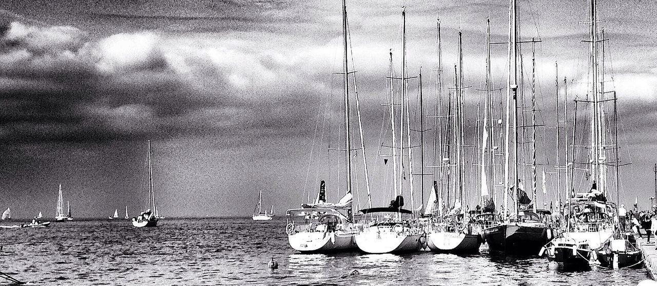 SAILBOATS MOORED IN SEA