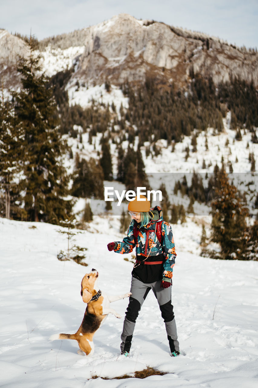 rear view of man skiing on snow covered landscape