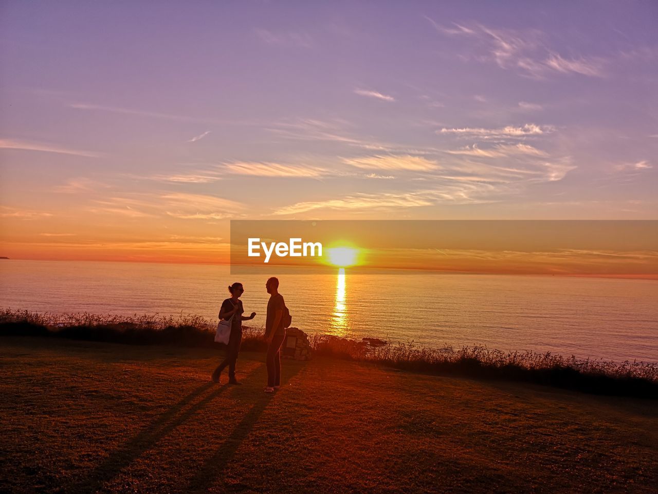 WOMEN ON BEACH DURING SUNSET