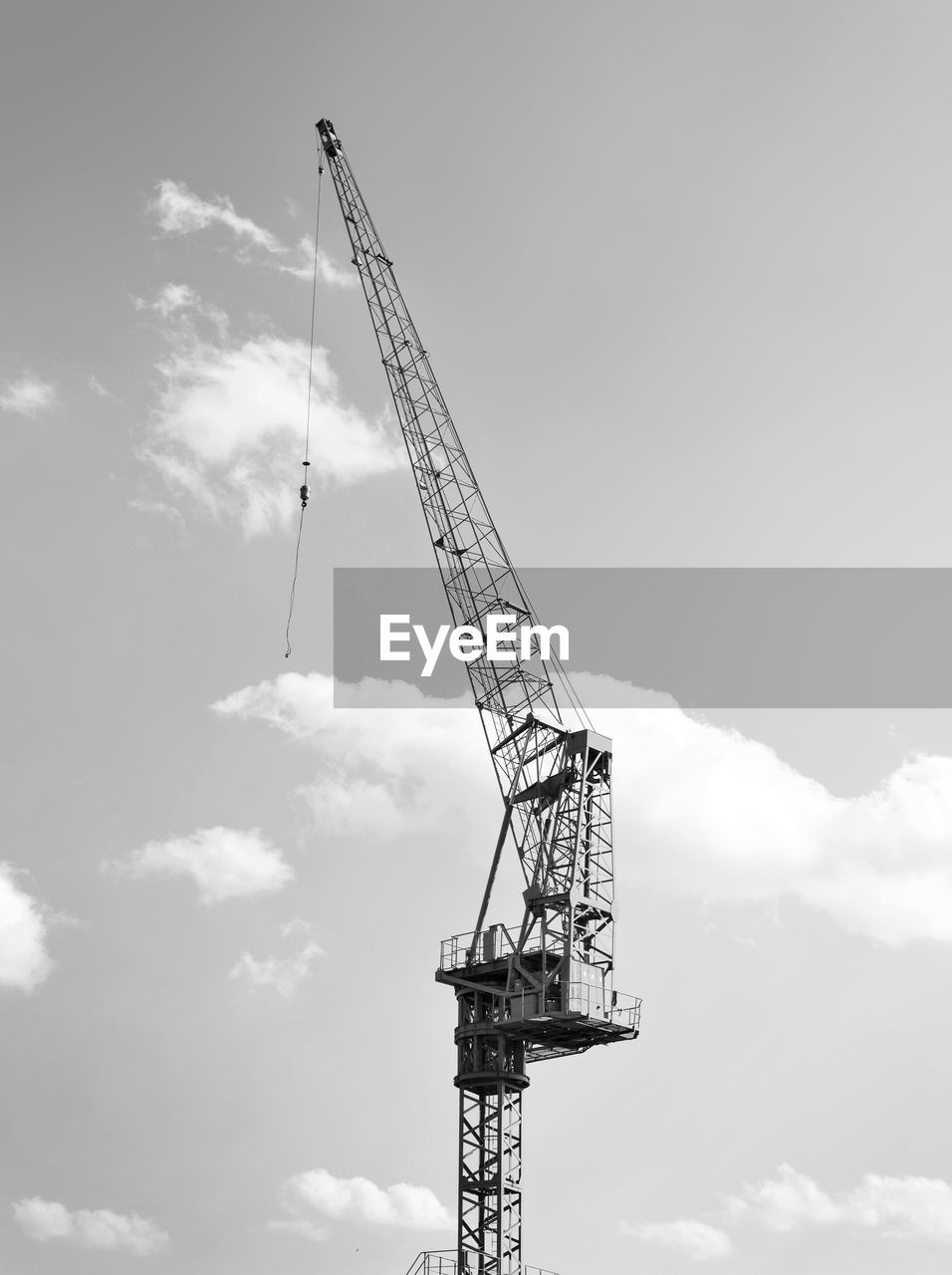 LOW ANGLE VIEW OF CRANES AGAINST SKY