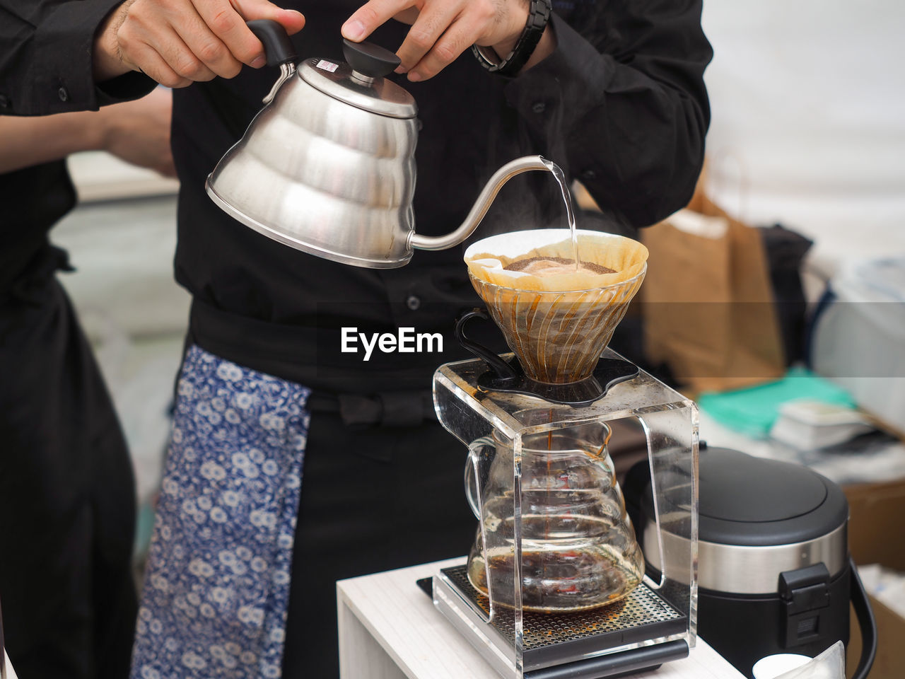 CLOSE-UP OF PREPARING POURING COFFEE