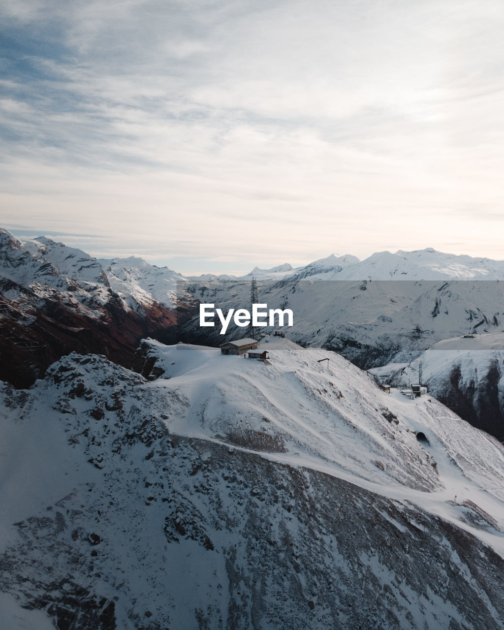 Scenic view of snow covered mountains against sky