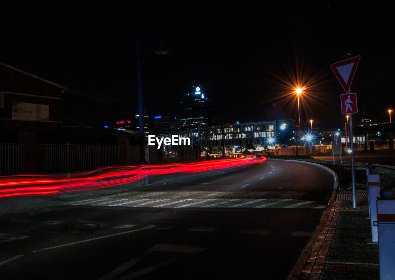 Light trails on road in city at night