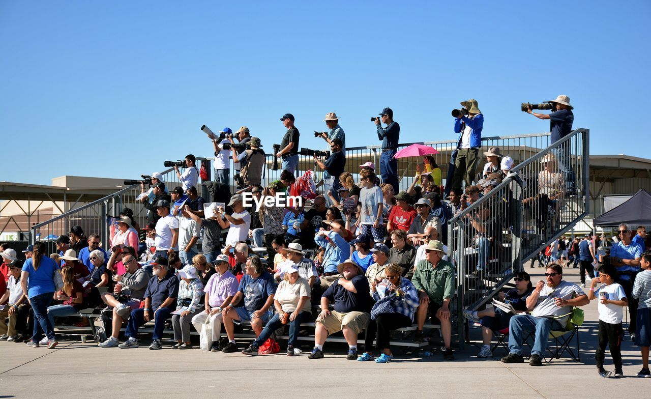 CROWD AT MARKET AGAINST SKY