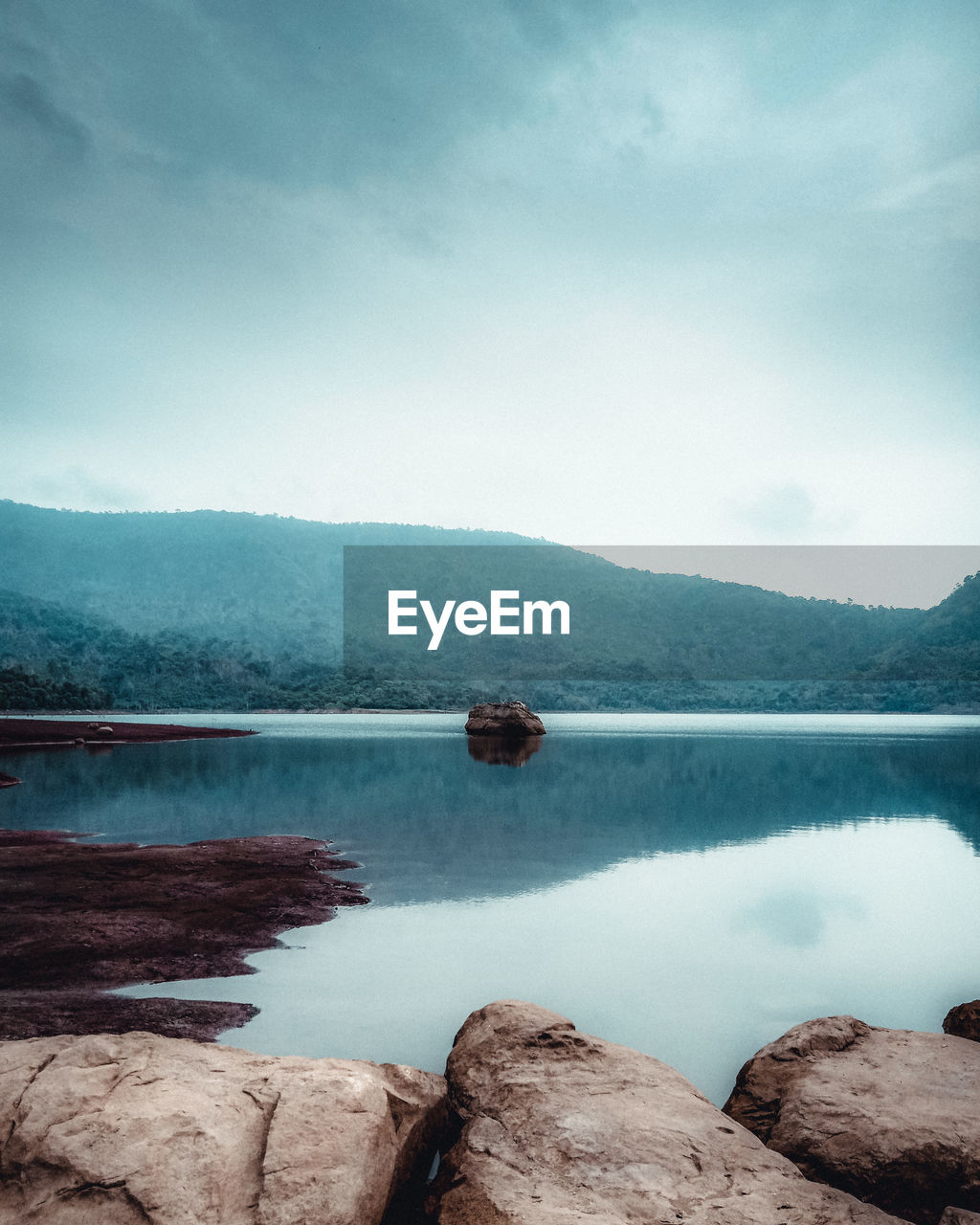 Scenic view of lake and mountains against sky