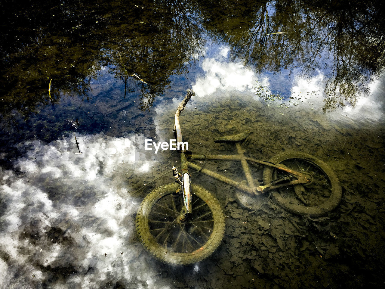 High angle view of abandoned bicycle in lake