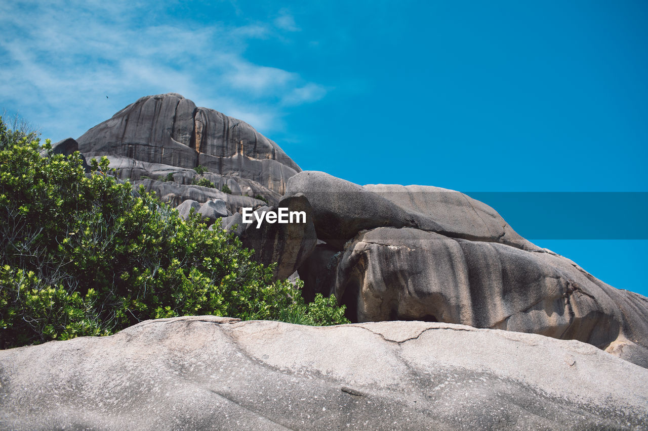 Low angle view of rock formation against blue sky