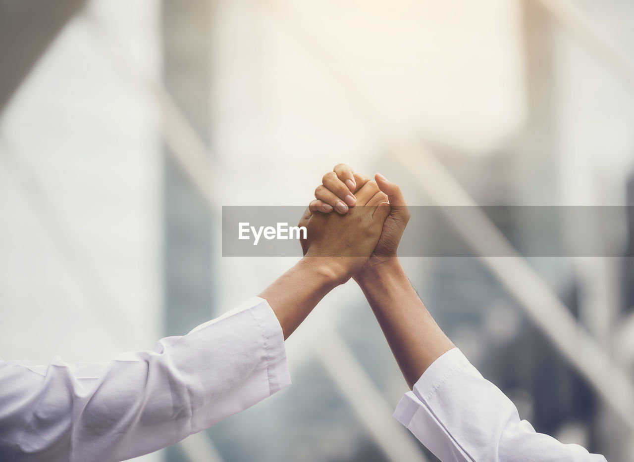 Cropped image of business people greeting each other outdoors