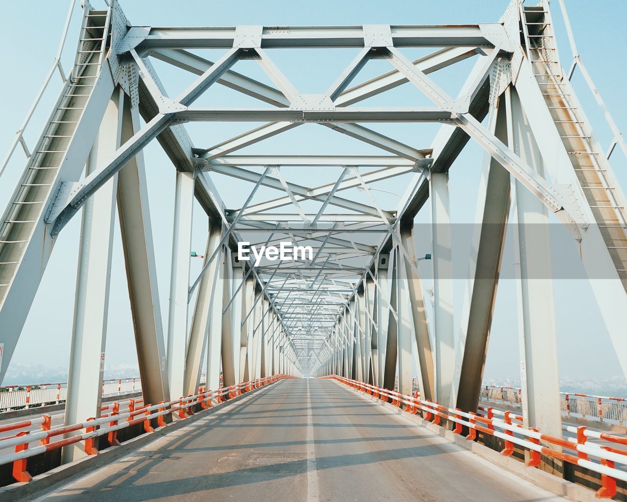 Empty road on bridge against sky